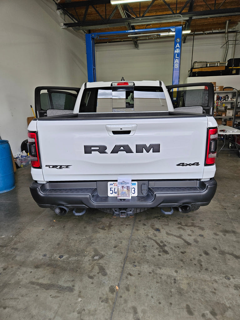 A picture of a RAM 1500 Crew Cab in White with doors open in the ESP Truck Accessories shop