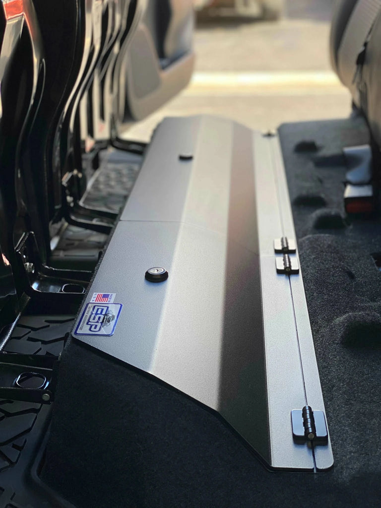 View of the under-seat lockable storage system installed in a Toyota Tacoma, showing the seat and cover