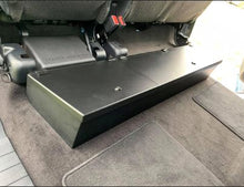 Load image into Gallery viewer, Interior view of a Ford F-Series truck showing the under-seat placement of the lockable storage